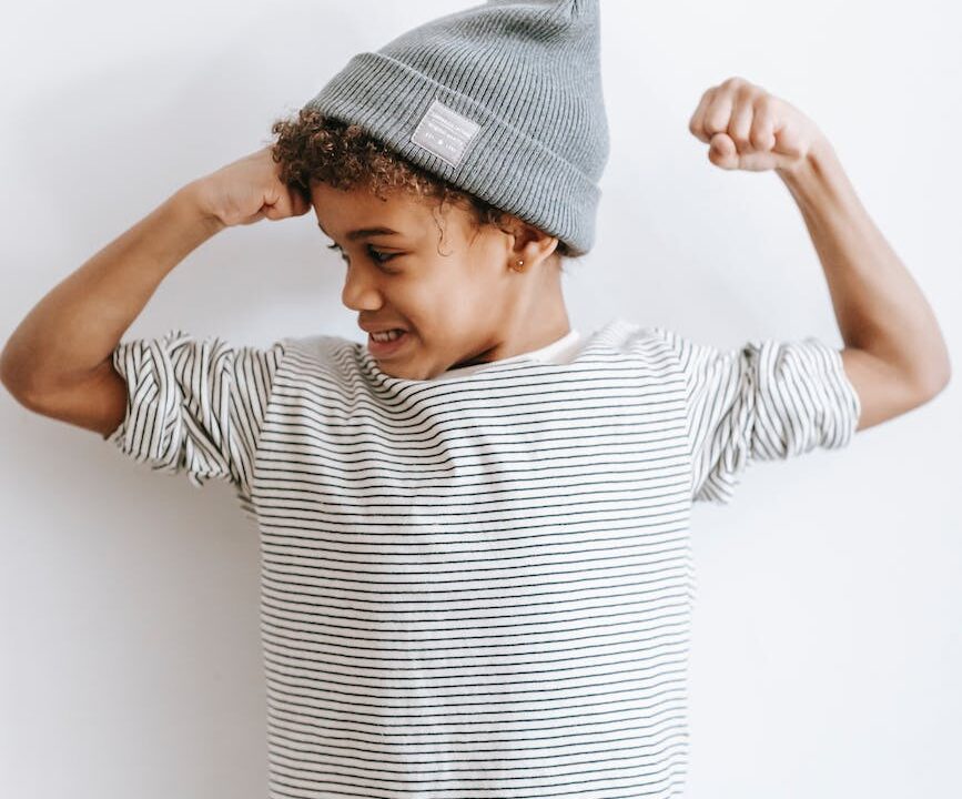 stylish black boy with arms bent in elbows