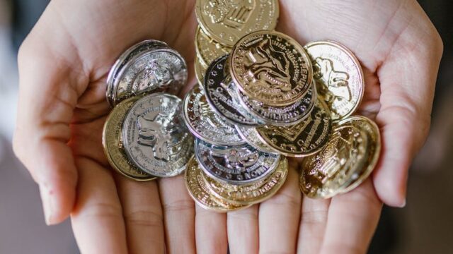 anonymous person holding coins