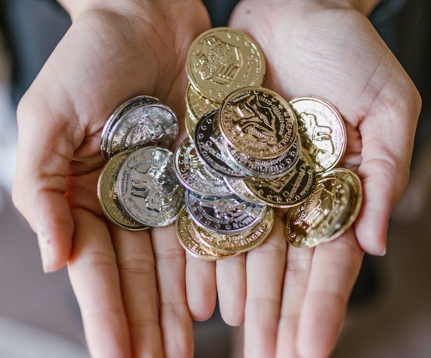 anonymous person holding coins